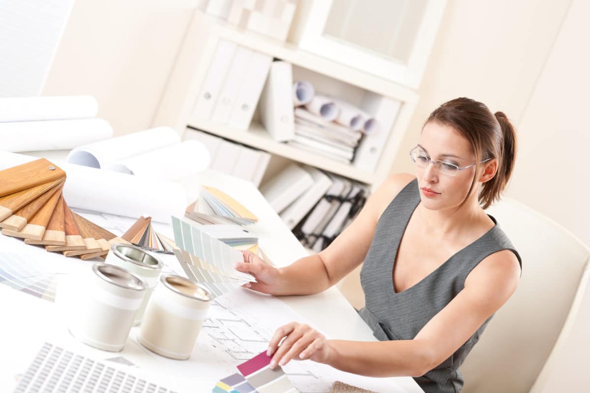 Female interior designer working with color swatch