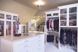 WHITE CUSTOM CLOSET WITH CLOSET ISLAND, CROWN MOLDING AND DESIGNER HARDWARE