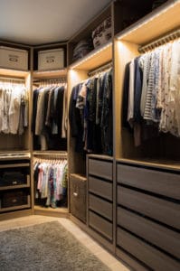Luxurious walk in custom closet with lighting and jewelry display.