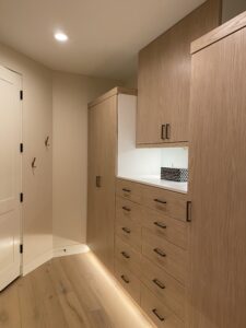 wooden custom wardrobe closet in curved space with bottom light