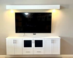 White floating media cabinets with LED lighting and TV